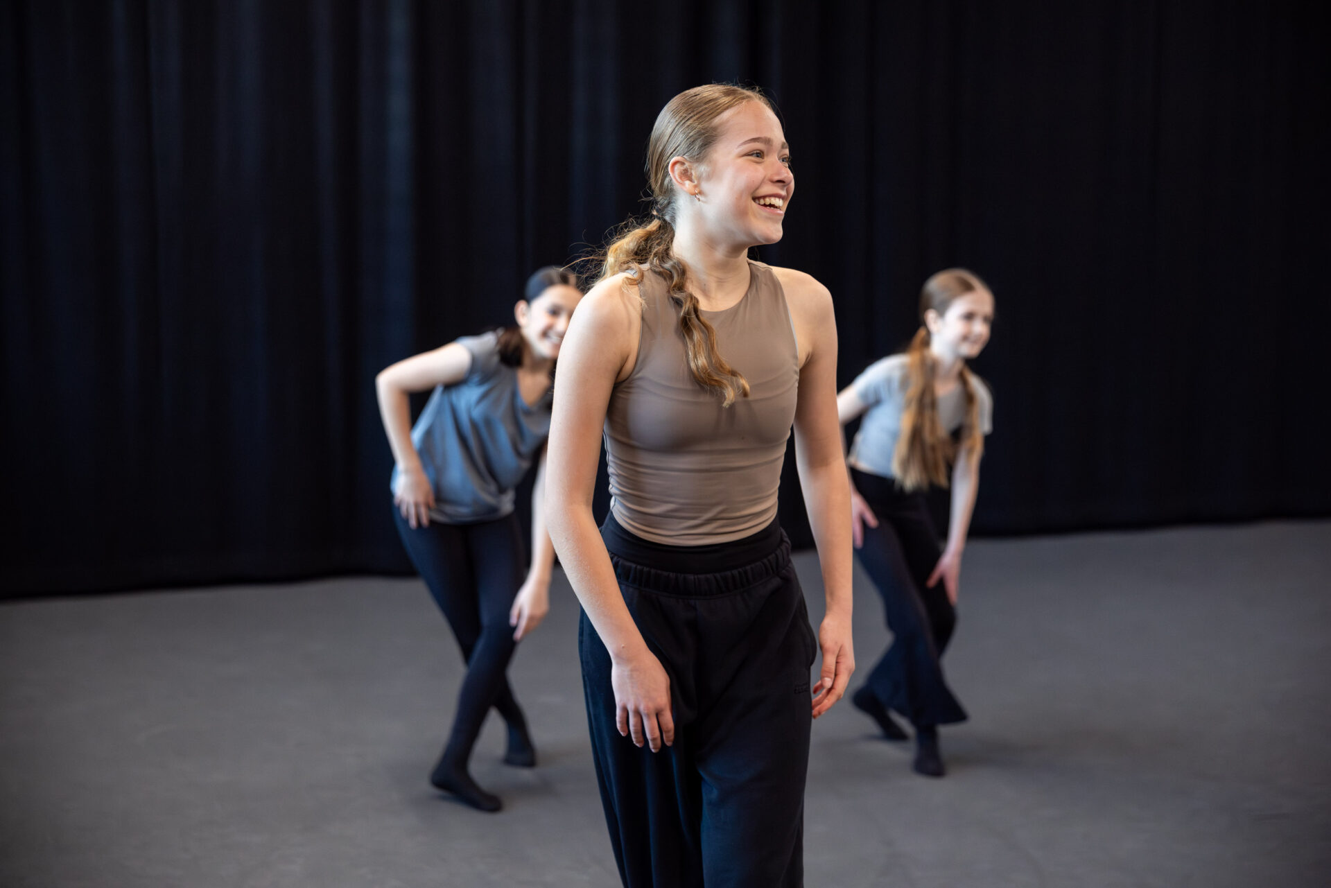 Youth ensemble dancer in grey singlet