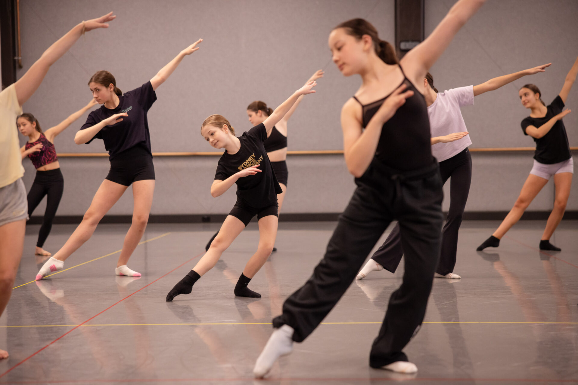 Young female dancer in the midst of fellow dancers